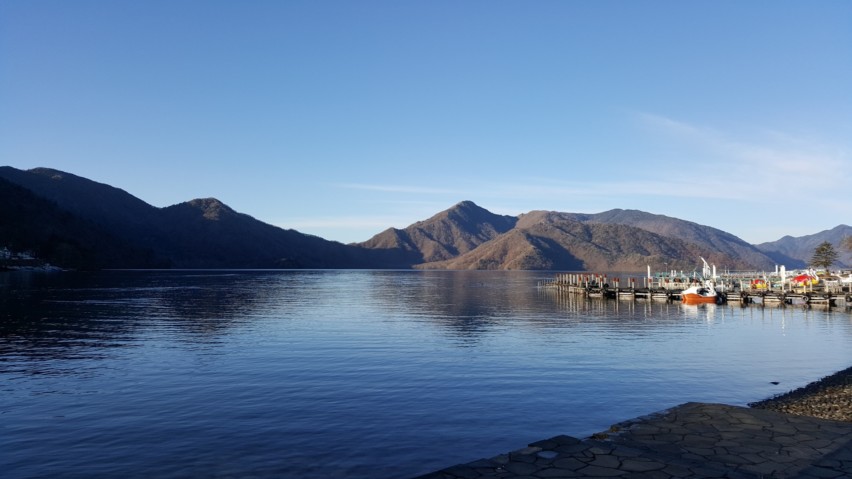 It was a sunny day when we visited Chuzenji Lake. The lake reflected the cloudless sky, mount Nantai, and boats along the deck.