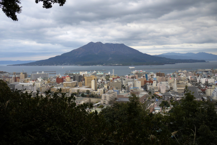 The city of Kagoshima with Sakurajima against the horizon