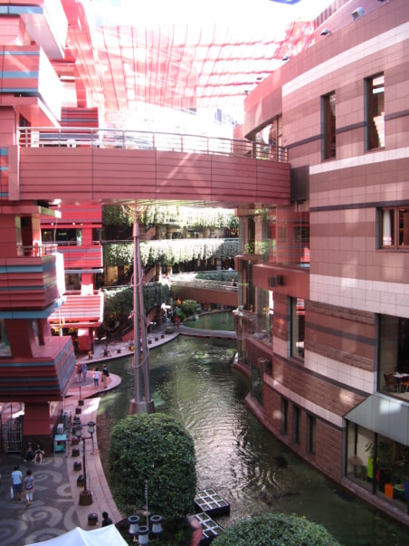 Pink buildings with a shallow canal between them