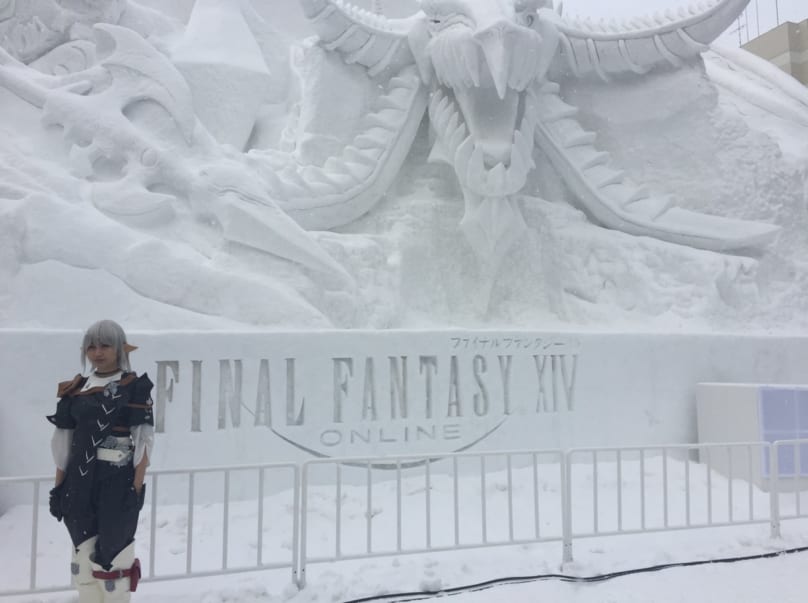 A cosplayer posing in front of the Artic Armageddon: The Final Fantasy XIV Online snow sculpture