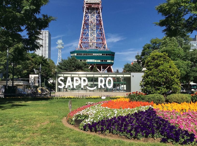 Odori Park with flowers and Sapporo TV Tower in background