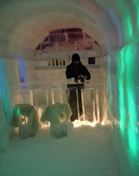A man prepares drinks at the snow village’s ice bar, Ningle Terrace, Furano, Hokkaido, Japan