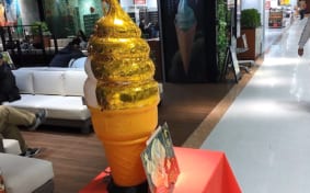 Giant display of an ice cream cone covered in gold leaf
