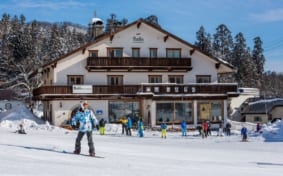 snowboarders in front of the Marillen Hotel