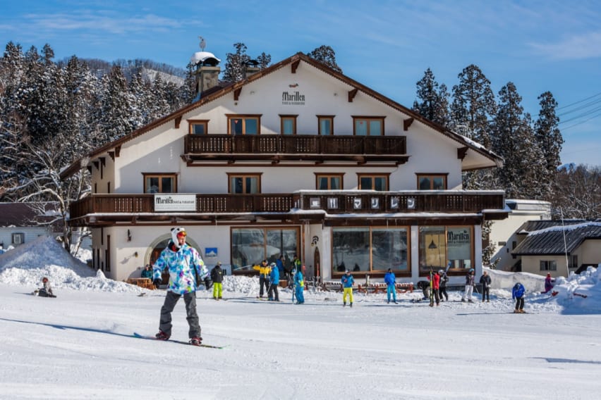 snowboarders in front of the Marillen Hotel