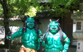 two statues of blue-green ao oni